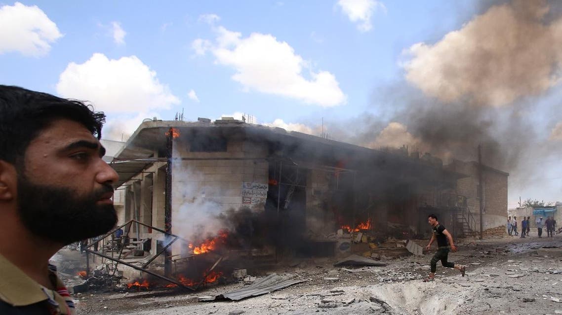 Syrian civilians react following an airstrike by Syrian regime forces in Maar Shurin on the outskirts of Maaret al-Numan in northwest Syria on July 16, 2019. (AFP)