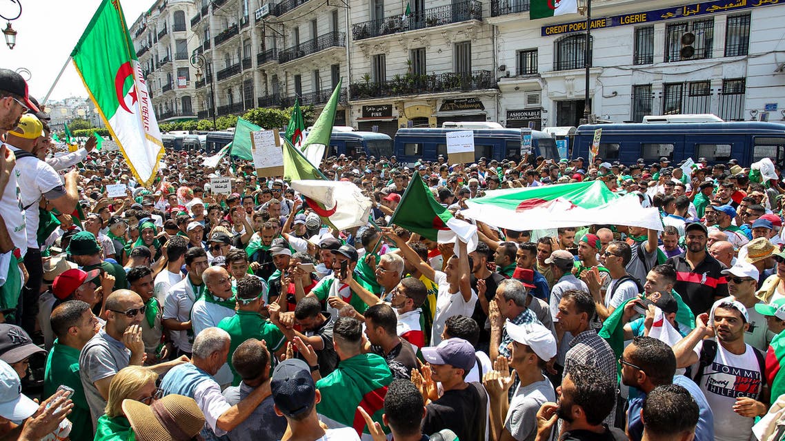 Algerian demonstrators chant slogans as they gather in the streets of the capital Algiers against the ruling class amid an ongoing political crisis in the country, on the 22nd consecutive Friday protest on July 19, 2019, coinciding with the Egypt 2019 Africa Cup of Nations final match between Algeria and Senegal. In April, long-standing president Abdelaziz Bouteflika resigned after weekly Friday protests against his expected candidacy for elections, and football fans have been heavily involved in demonstrations.