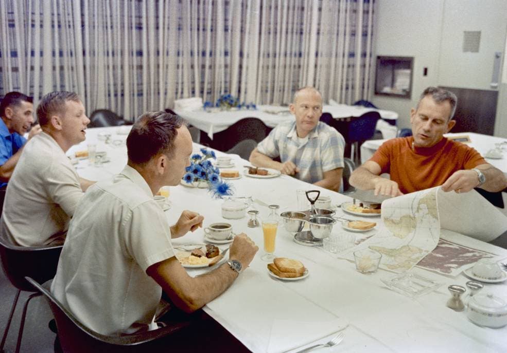 In this image obtained from NASA, Apollo 11 astronauts Neil Armstrong (2nd L), Michael Collins (3rd L) and Buzz Aldrin (C) have their pre-launch breakfast on July 16, 1969, with astronaut William Anders (L) and Chief of the Astronaut Office Donald K. “Deke” Slayton. (AFP)