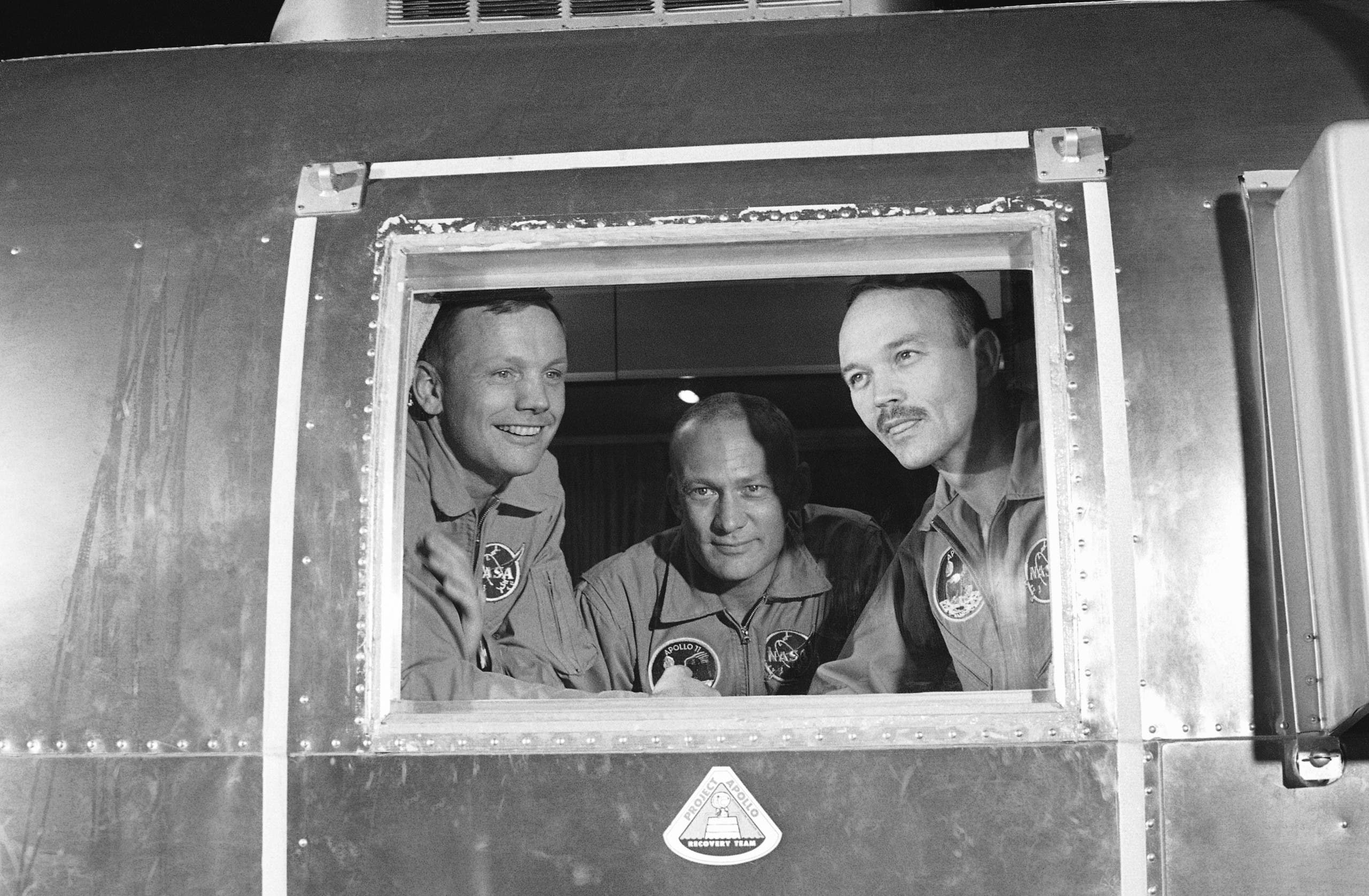 In this July 27 1969 file photo, Apollo 11 crew members Neil Armstrong, Buzz Aldrin and Michael Collins sit inside a quarantine van in Houston. (AP)