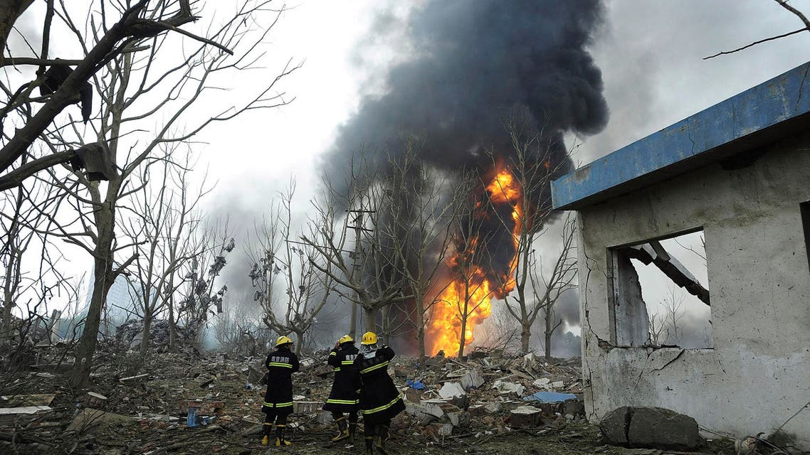 Firemen walk past debris after a factory explosion in Nanjing, in east China's Jiangsu province, Wednesday, July 28, 2010. (AP)