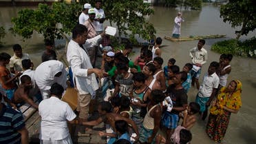 Medical officers distribute medicines to flood victims in Gagalmari, in the northeastern Indian state of Assam, on July 19, 2019. (AP)