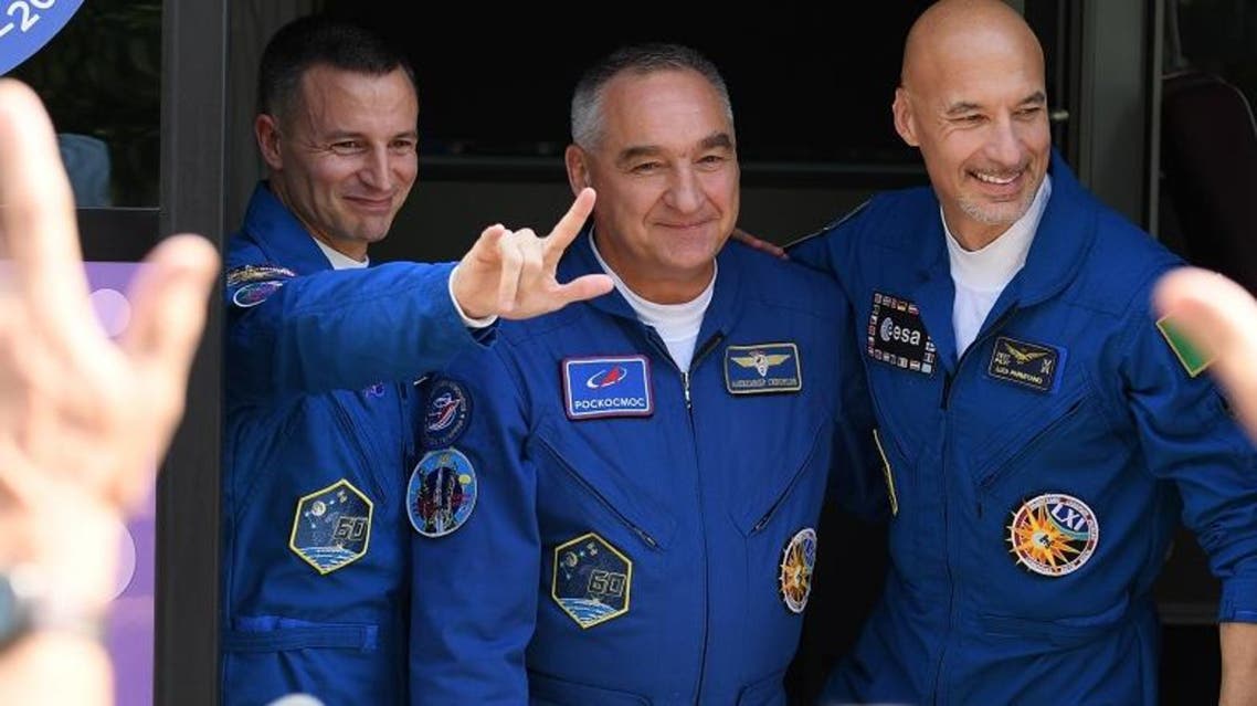 Members of the International Space Station (ISS) expedition 60/61, Andrew Morgan, Alexander Skvortsov and Luca Parmitano pose by a bus during a farewell ceremony on July 20, 2019. (AFP)