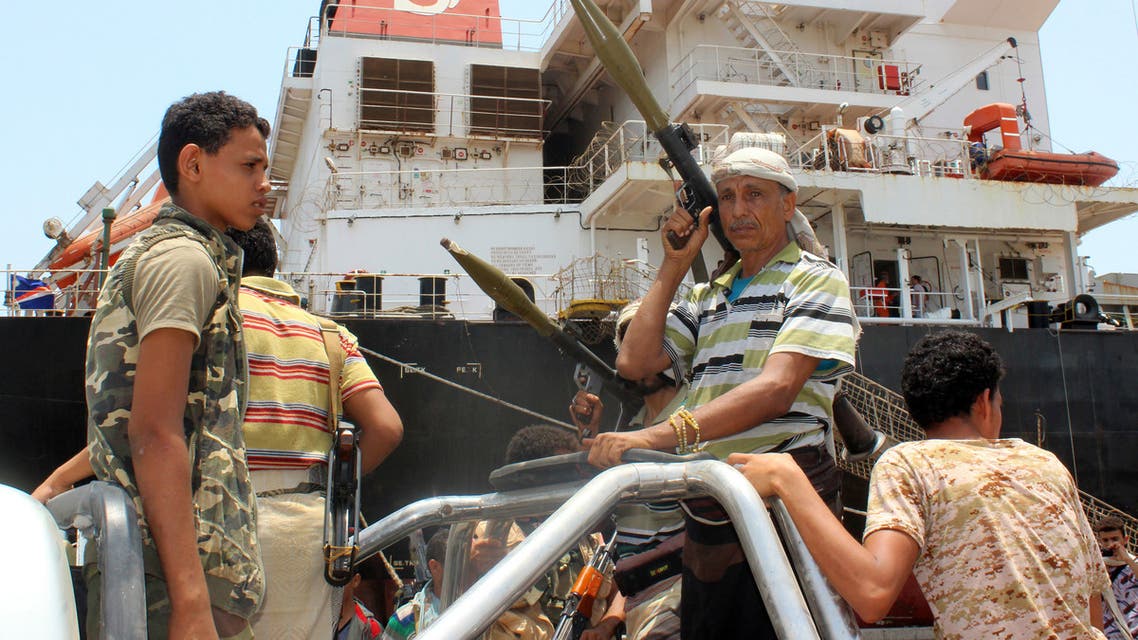 Huthi rebels stand at attention at the Saleef port on May 11, 2019, in the Red Sea port of Hodeidah, ahead of their withdrawal. A senior pro-government official in Yemen accused Huthi rebels of faking an announced pullout Saturday from three Red Sea ports, as a UN source said monitoring of the much delayed withdrawal in Hodeida province was underway.