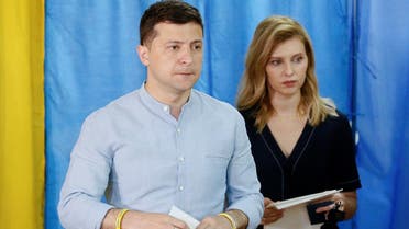 Ukraine’s President Volodymyr Zelenskiy and his wife Olena walk before casting their ballots at a polling station during a parliamentary election in Kiev, Ukraine, on July 21, 2019. (Reuters)