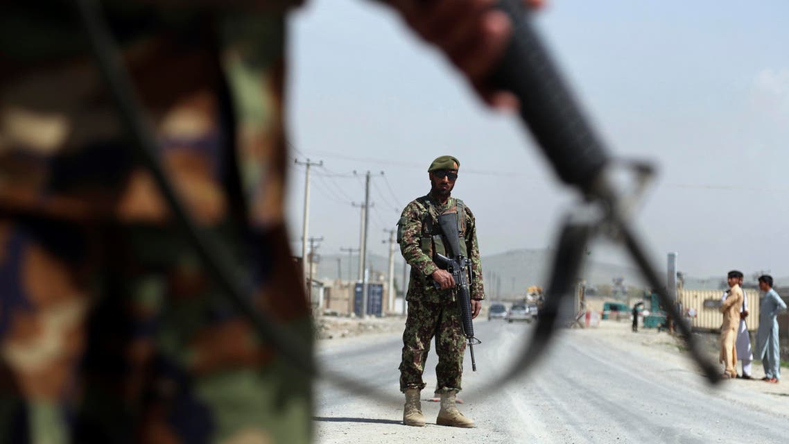 in this Sunday, April 28, 2019 photo, Afghan National Army soldiers stand guard at a checkpoint on the Jalalabad-Kabul road, on the outskirts of Kabul, Afghanistan. (AP)
