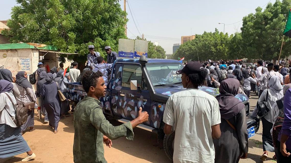 Sudanese protesters march past a security forces’ vehicle during a demonstration commemorating protesters killed in past clashes, in the center of the capital Khartoum on July 23, 2019. (AFP)