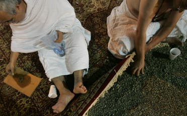 Muslim pilgrims collect stones to be thrown at a pillar representing the devil in Muzdalifah. (AP)