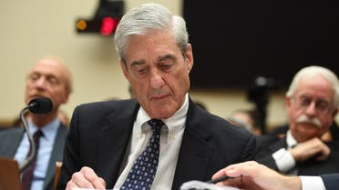 Former Special Prosecutor Robert Mueller looks at documents as he testifies before Congress on July 24, 2019, in Washington, DC. Robert Mueller's long-awaited testimony to the US Congress opened Wednesday amid intense speculation over whether he would implicate President Donald Trump in criminal wrongdoing.