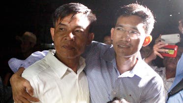 Two former Radio Free Asia reporters Uon Chhin, left, and Yeang Socheamet, right, hold together after they walk outside the main prison of Prey Sar at the outskirt of Phnom Penh, Cambodia (AP)