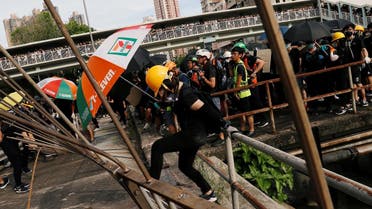 Protesters pull down a fence near Nam Pin Wai village during a protest against the Yuen Long attacks in Yuen Long, New Territories, Hong Kong. (Reuters)