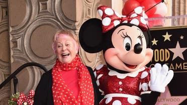 Voice actress Russi Taylor, who has voiced Minnie Mouse since 1986, poses with Minnie Mouse during a star ceremony in celebration of the 90th anniversary of Disney's Minnie Mouse at the Hollywood Walk of Fame. (File photo: AFP)