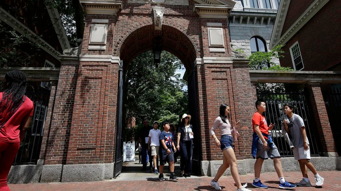 In this Tuesday, July 16, 2019 photo people walk through a gate as they depart Harvard Yard, at Harvard University, in Cambridge, Mass. (AP)