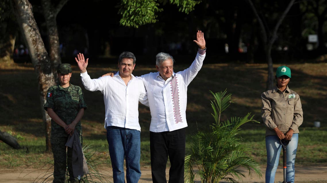 Honduras' President Juan Orlando Hernandez, left, and Mexico's President Andrés Manuel López Obrador, pose for photos on a military base in Minatitlan, Mexico, Saturday, July 27, 2019. (AP)