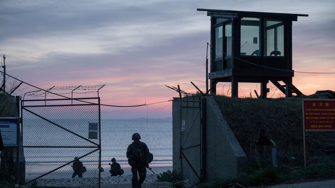 In a photo taken on April 24, 2018 South Korean soldiers exit a beach before the coast of North Korea (C) on Yeonpyeong island, near the 'northern limit line' sea boundary. (AFP)
