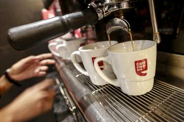 An employee prepares coffee for customers at a Cafe Coffee Day outlet in Mumbai, India. (Reuters)