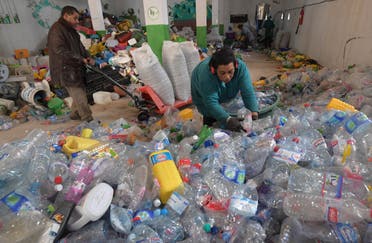 Employees in a plastic recycling plant sift through plastic. (File photo: AFP)