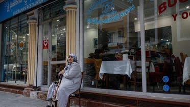 In this photo taken Thursday, Dec. 14, 2017, a Uighur woman sits outside a shop in the Uighur immigrant neighborhood of Zeytinburnu. (AP)