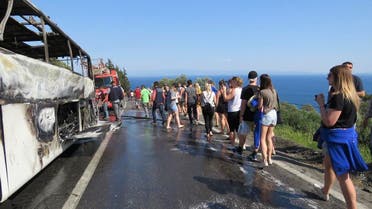 File photo passengers, mainly tourists, gathered around their bus which burst into flames n Kucukkuyu, western Turkey. (AP)