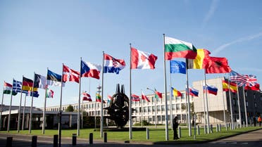 Flags of member countries flap in the wind in front of NATO headquarters in Brussels on Tuesday, Oct. 22, 2013. (AP)
