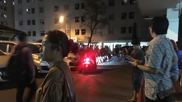 Resident stand outside an apartment block after a strong earthquake hit the area around Jakarta on August 2, 2019. (AFP)