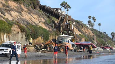 Search and rescue personnel work at the site of a cliff collapse at a popular beach Friday, Aug. 2, 2019, in Encinitas, California. (AP)