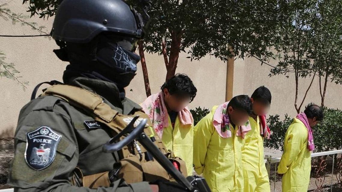 Handcuffed suspects are displayed along with 29 kilograms of hashish at the federal police headquarters in Basra. (Illustrative photo: AP)