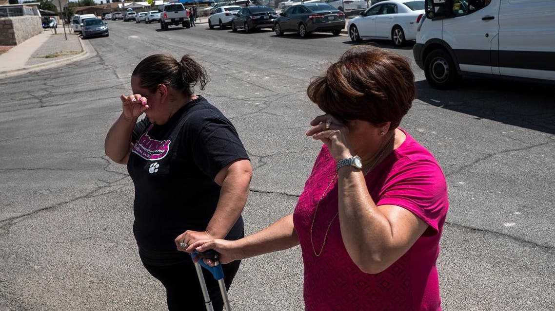 Residents Erica Rios, 36, and Alma Rios, 61, cry outside a reunification center at MacArthur Elementary School, following a deadly mass shooting, in El Paso, Texas. (AFP)
