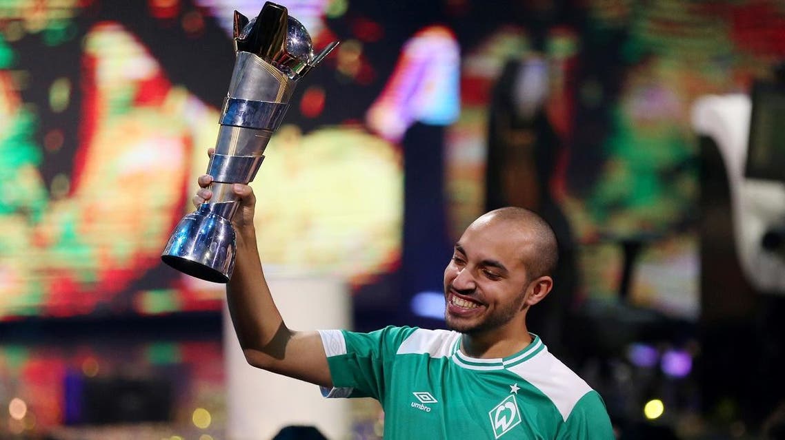Mo Harkous (MoAuba) of Germany celebrates with the trophy after winning the FIFA eWorld Cup at O2 Arena, London, Britain, on August 4, 2019. (Reuters)