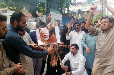 Pakistani Kashmiris burn a photograph of Indian Prime Minister Narendra Modi during an anti-Indian protest in Muzaffarabad, the capital of Pakistan-administered Kashmir. (AFP)