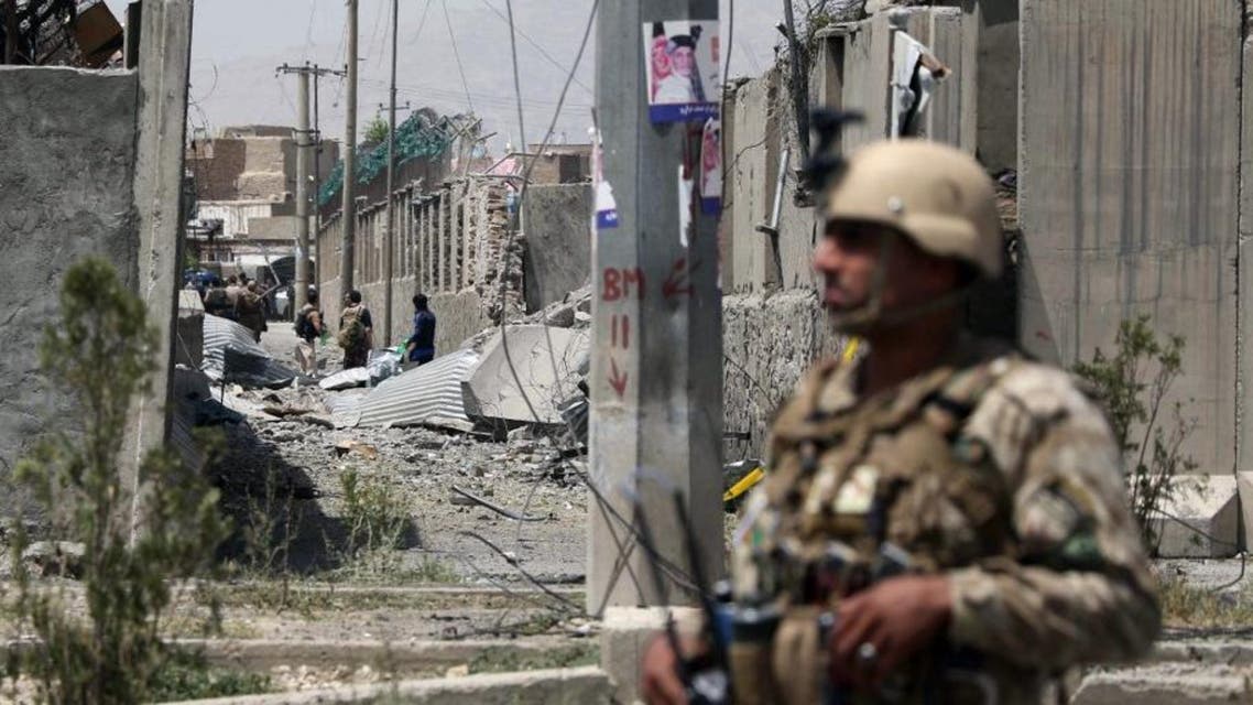 An Afghan security personnel stands guard at the site where a Taliban car bomb detonated at the entrance of a police station in Kabul on August 7, 2019. (AFP)
