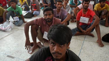 Rohingya migrants sit on the floor at the authority's district office of Rattaphum, Songkla province, southern Thailand, as they were found abandoned in Khao Kaew mountain near the Thai-Malaysia border, Saturday, May 9, 2015. (AP)