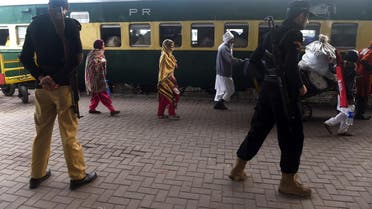Pakistani policemen stand guard as stranded Indian passengers travelling with the Samjhauta Express, also called the Friendship Express that runs between New Delhi and Attari in India and Lahore in Pakistan, arrive at Lahore railway station on March 4, 2019. (AFP)
