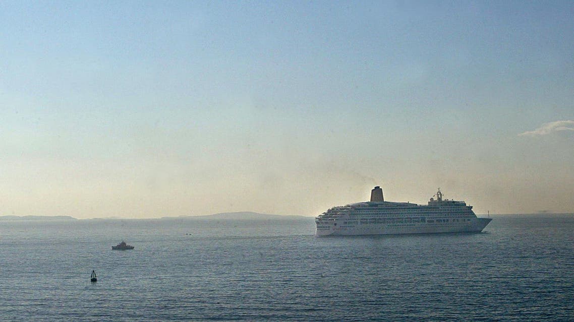 Greek coastal guard boats watch the Aurora, a cruise liner owned by the British company P&O sail away from the port of Piraeus near Athens, 31 October 2003. (AFP)