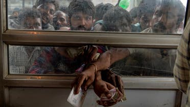 Labourers from across India working in Kashmir buy bus tickets at a counter of Jammu and Kashmir Tourist Reception Centre (JKTRC) to leave the city due to the heightened security situation in Srinagar on August 7, 2019. (AFP)