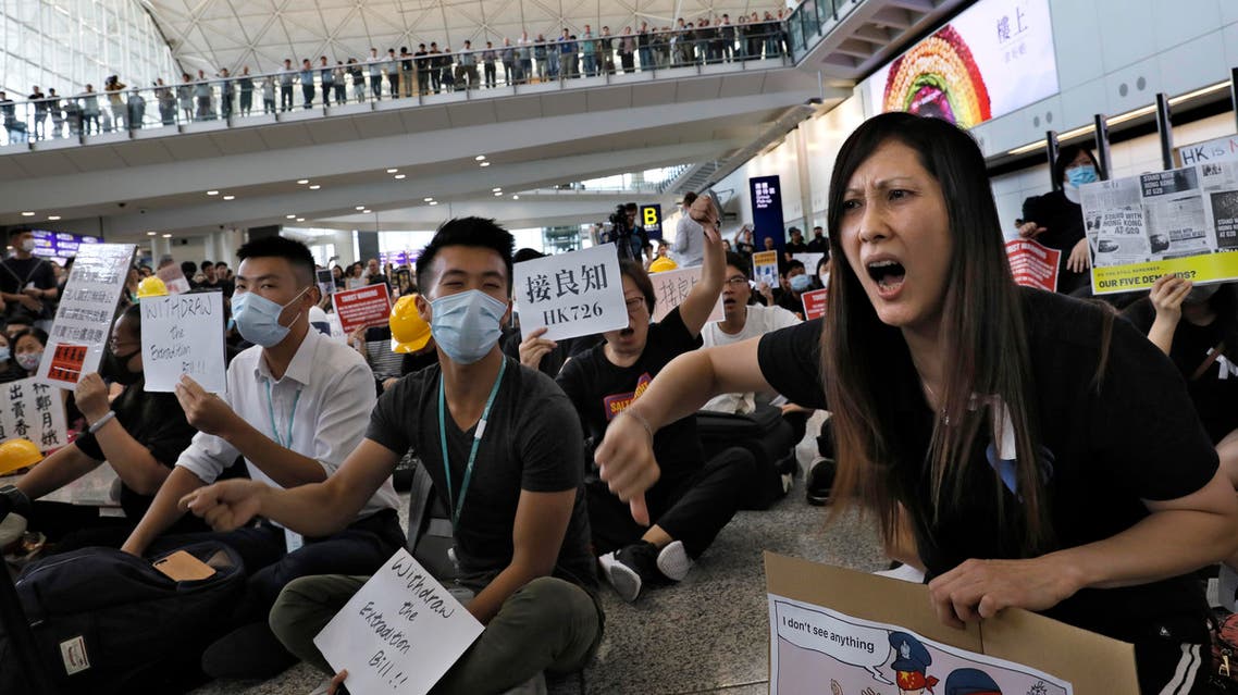 Demonstrators shout slogans during a protest at Hong Kong International Airport, Friday, July 26, 2019 (AP)