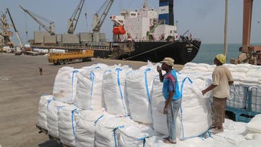 Yemenis receive sacks of food aid packages from the World Food Programme (WFP) in the Yemeni port city of Hodeida on June 25, 2019. (AFP)