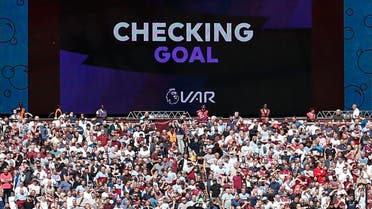 The big screen informs the crowd that the VAR (video assistant referee) is checking Manchester City's third goal, which is ruled as a valid goal. (AFP)