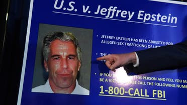 An employee of the Southern District of New York hangs a sign containing a photograph of Jeffrey Epstein, charged of sex trafficking of minors and conspiracy to commit sex trafficking of minors, in New York, U.S., July 8, 2019. (Reuters)