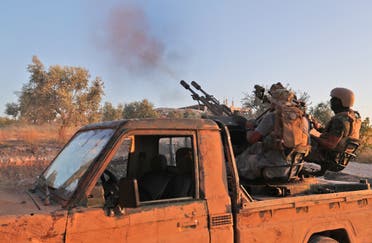 Fighters from the former al-Qaeda Syrian affiliate Hayat Tahrir al-Sham fire an anti-aircraft gun mounted on a pickup truck in Syria's southern Idlib province on August 7, 2019. (File photo: AFP)