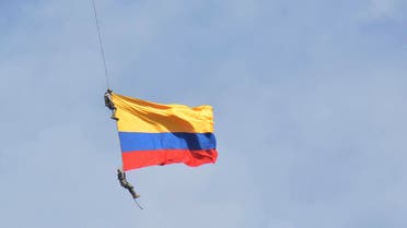 Two members of Colombia’s air force have plunged to their deaths wrapped in their nation’s flag when a cable hanging from a helicopter snapped while they were performing a mid-air stunt. (AP)