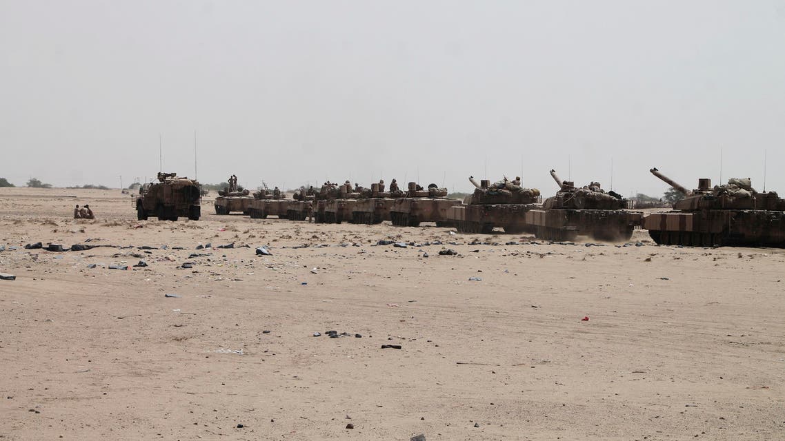 In this photo taken on Monday, Aug. 3, 2015, tanks and armored vehicles belonging to fighters against Shiite rebels known as Houthis gather on a road leading to Al-Anad base near Aden in the southern province of Lahej, Yemen. Pro-government troops seized the base from Shiite rebels on Monday, military officials said. The capture of Al-Anad was a significant victory for the forces allied to Yemen's exiled President Abed Rabbo Mansour Hadi in their battle to reverse the gains of Houthis. (AP Photo/Wael Qubady)