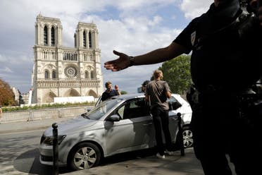 Police officers clear the area around Notre Dame cathedral in Paris, Monday, Aug. 12, 2019. (AP)