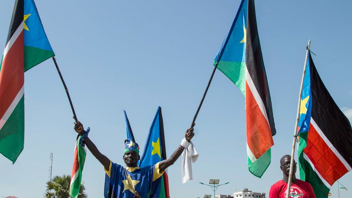 People wave the national flags of South Sudan during a peace ceremony in Juba, South Sudan, on October 31, 2018. South Sudan rebel leader Riek Machar returned to the capital Juba for the first time in more than two years on October 31, 2018, saying he arrived with a message of peace.