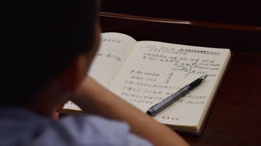 This photo taken on June 26, 2019 shows an adult student taking notes on Xi Jinping thought in a class in a school in Beijing. (File photo: AFP)