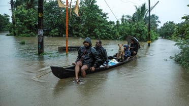 Residents are being evacuated from their home to a safer place following floods warnings, on a wooden boat in Kochi in the Indian state of Kerala on August 10, 2019. (AFP)