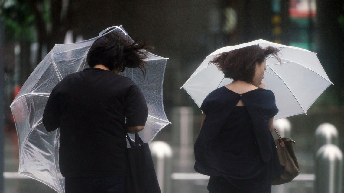 Women walk in the wind and rain as Typhoon Shanshan approaches Wednesday, Aug. 8, 2018, in Tokyo. (AP)