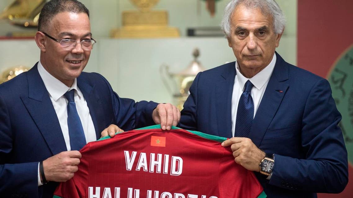 Bosnian coach Vahid Halilhodzic poses with Fouzi Lekjaa (L), President of Morocco’s Royal Football Federation (FRMF), after signing on as the new coach of the Moroccan national football team during a press conference in the capital Rabat on August 15, 2019. (AFP)