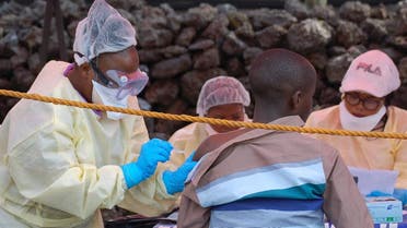 A young man receives a vaccine against Ebola from a nurse in Goma on August 7, 2019. (AFP)