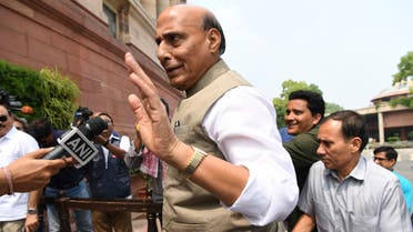 Indian Defence Minister Rajnath Singh (C) arrives at the Parliament House in New Delhi on August 5, 2019.